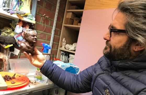 Alessandro Cervizzi gazing on his clay bust figure