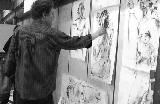 Black and white image of HSoA tutor working on art