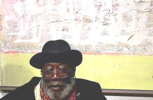 Frank bowling infront of painting