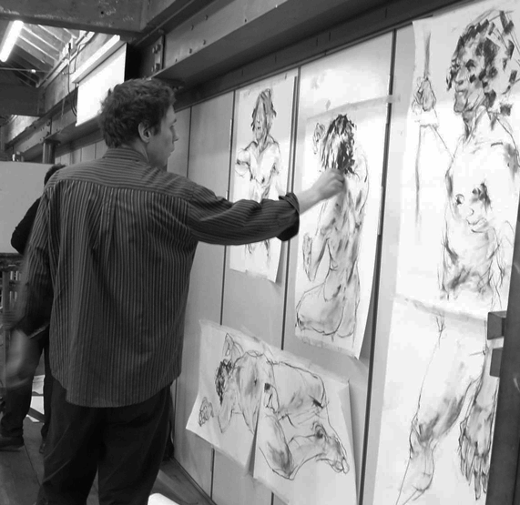 Black and white image of HSoA tutor working on art